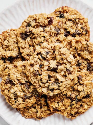 Vegan Oatmeal Raisin Cookies with Coconut Oil on a platter with almond milk.