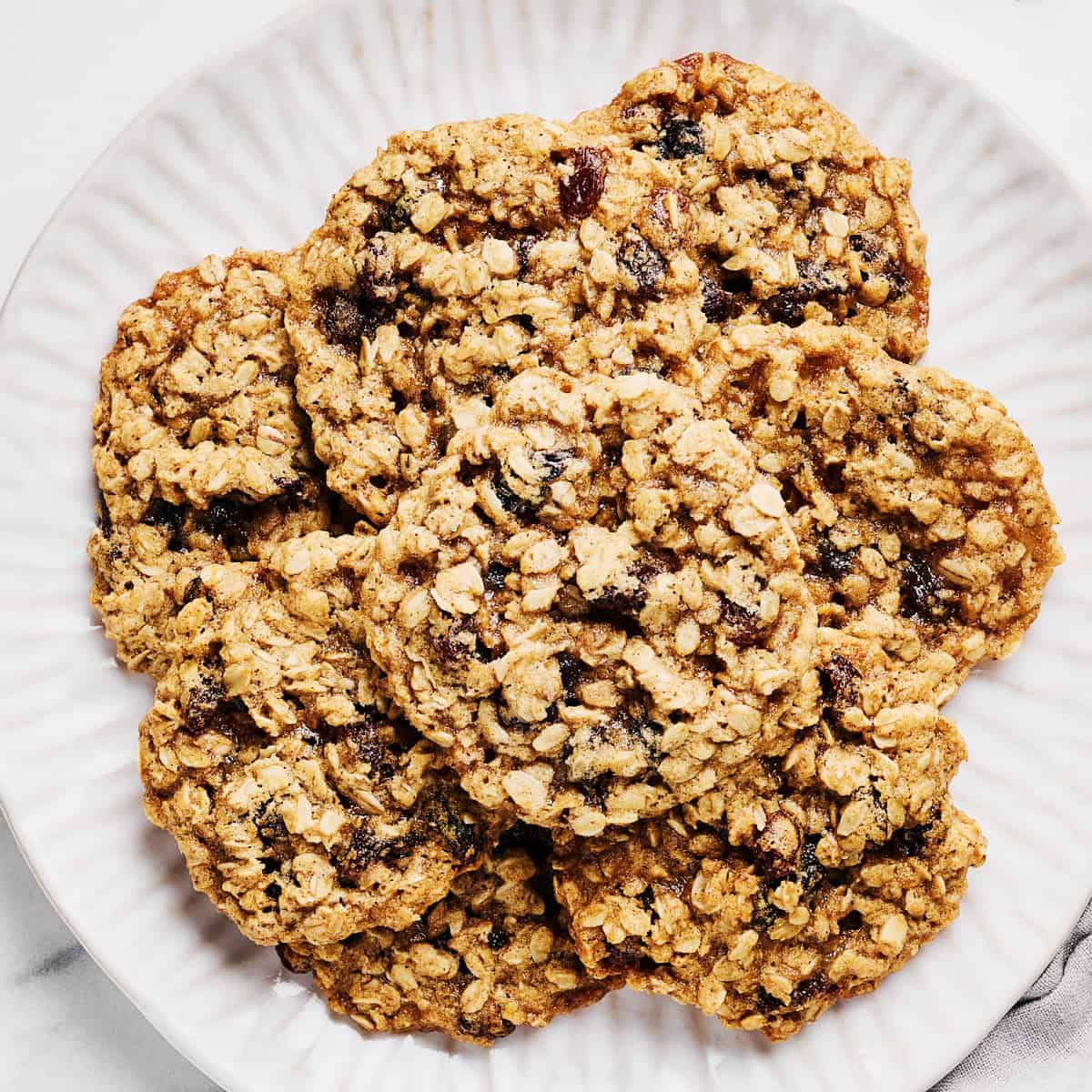 Vegan Oatmeal Raisin Cookies with Coconut Oil on a platter with almond milk.